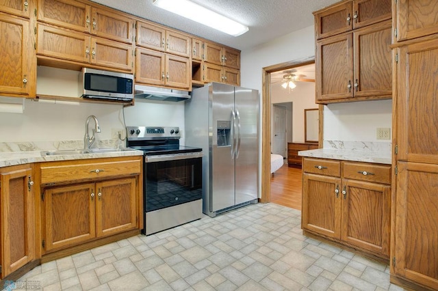 604 2nd Ave S, Kindred, ND 58052 - kitchen featuring stainless steel appliances, under cabinet range hood, light countertops, open shelves, and ceiling fan