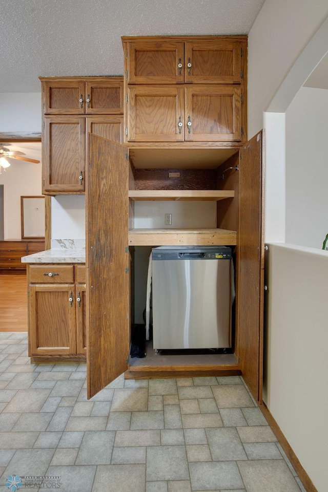 604 2nd Ave S, Kindred, ND 58052 - kitchen featuring stainless steel dishwasher, open shelves, brown cabinets, and light countertops