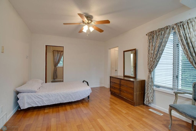 604 2nd Ave S, Kindred, ND 58052 - bedroom with multiple windows, light wood-style floors, and ceiling fan