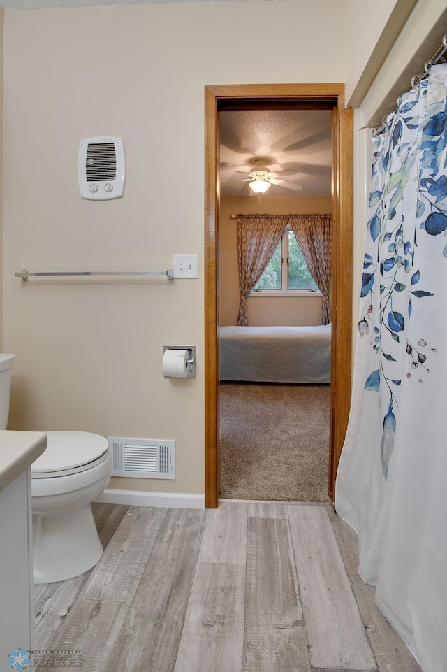 604 2nd Ave S, Kindred, ND 58052 - ensuite bathroom featuring wood finished floors, vanity, a ceiling fan, and a shower with curtain