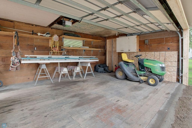 604 2nd Ave S, Kindred, ND 58052 - garage featuring wooden walls, a garage door opener, and a workshop area