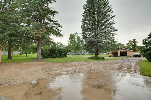 604 2nd Ave S, Kindred, ND 58052 - view of grassy yard with a garage, driveway, and an outbuilding