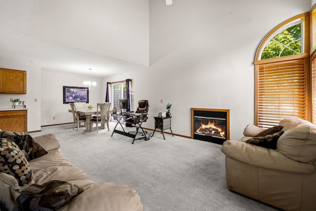 930 106th Ln NW Unit 9Nw, Coon Rapids, MN 55433 - living room featuring light colored carpet, a chandelier, a glass covered fireplace, and a high ceiling
