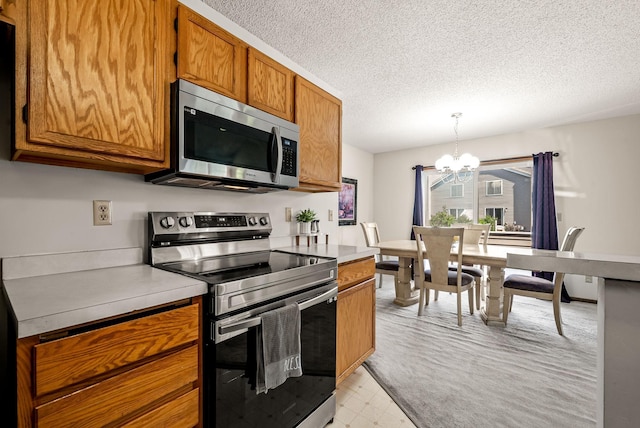 930 106th Ln NW Unit 9Nw, Coon Rapids, MN 55433 - kitchen with appliances with stainless steel finishes, a chandelier, brown cabinetry, light countertops, and a textured ceiling