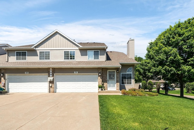 930 106th Ln NW Unit 9Nw, Coon Rapids, MN 55433 - view of front of house with driveway, a front lawn, a chimney, board and batten siding, and brick siding