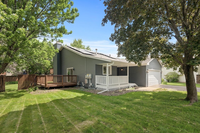 6722 116th Cir, Champlin, MN 55316 - back of house with an attached garage, a porch, concrete driveway, and solar panels