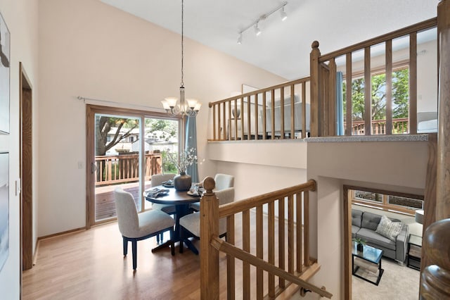 6722 116th Cir, Champlin, MN 55316 - dining room with a chandelier, wood finished floors, a high ceiling, and track lighting