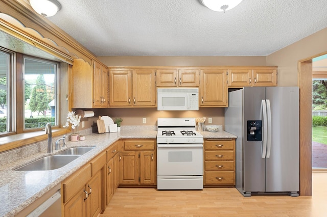 6722 116th Cir, Champlin, MN 55316 - kitchen featuring white appliances, light wood-style floors, a textured ceiling, and light stone countertops