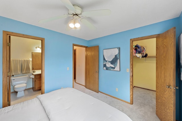 6722 116th Cir, Champlin, MN 55316 - carpeted bedroom featuring a walk in closet, a closet, ensuite bath, and ceiling fan
