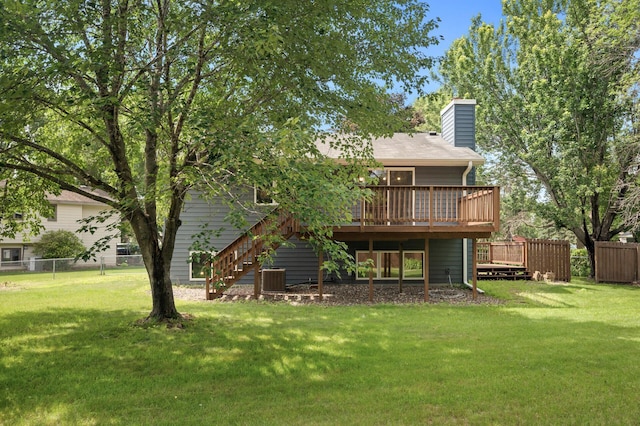 6722 116th Cir, Champlin, MN 55316 - rear view of property with a deck, stairs, and a chimney