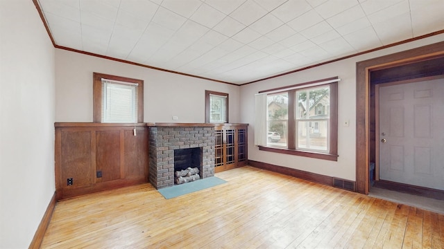 1038 23rd Ave SE, Minneapolis, MN 55414 - unfurnished living room with a fireplace, ornamental molding, and hardwood / wood-style flooring
