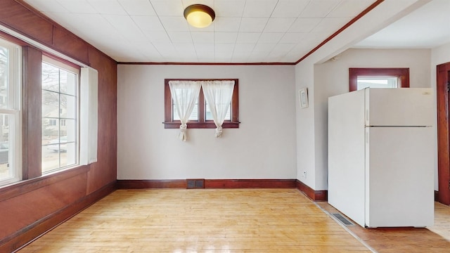 1038 23rd Ave SE, Minneapolis, MN 55414 - spare room featuring light wood-style flooring, plenty of natural light, and crown molding