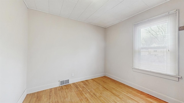 1038 23rd Ave SE, Minneapolis, MN 55414 - unfurnished room with hardwood / wood-style flooring and baseboards
