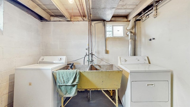 1038 23rd Ave SE, Minneapolis, MN 55414 - laundry room featuring washer and clothes dryer and concrete block wall