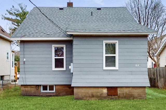 1038 23rd Ave SE, Minneapolis, MN 55414 - back of property with a shingled roof and a chimney