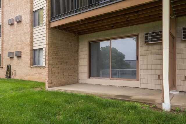 1903 Silver Bell Rd Unit 108, Eagan, MN 55122 - exterior space featuring brick siding, a yard, a balcony, and a wall mounted AC