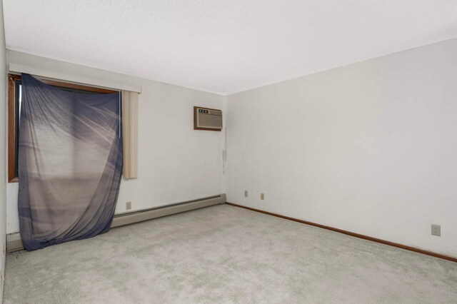 1903 Silver Bell Rd Unit 108, Eagan, MN 55122 - empty room with a wall mounted AC, baseboard heating, and carpet