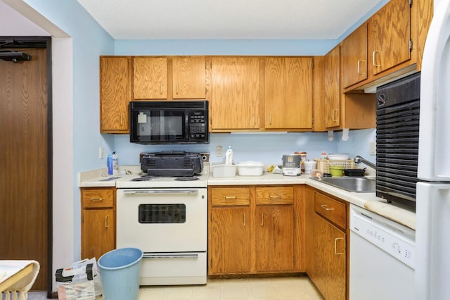 1887 Silver Bell Rd Unit 115, Eagan, MN 55122 - kitchen featuring white appliances, light countertops, and brown cabinets
