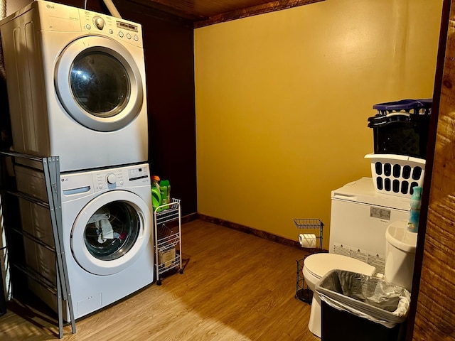 316 2nd St NE, Menahga, MN 56464 - laundry room featuring stacked washing machine and dryer and wood finished floors