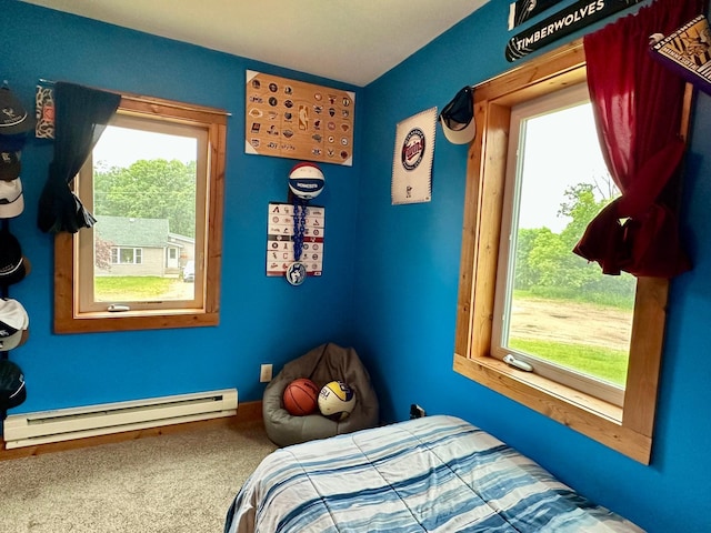 316 2nd St NE, Menahga, MN 56464 - bedroom featuring baseboard heating, multiple windows, and carpet floors