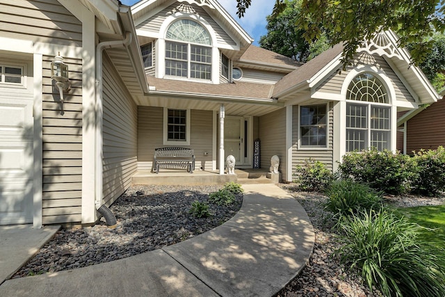 2668 Waterford Ct, Saint Cloud, MN 56301 - view of exterior entry featuring covered porch, an attached garage, and roof with shingles