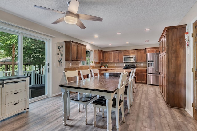 2668 Waterford Ct, Saint Cloud, MN 56301 - dining space with healthy amount of natural light, light wood-style floors, ceiling fan, a textured ceiling, and recessed lighting