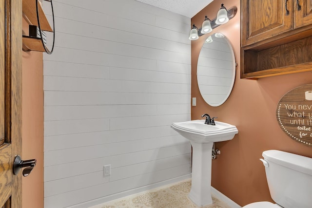 2668 Waterford Ct, Saint Cloud, MN 56301 - half bath featuring toilet and wood walls