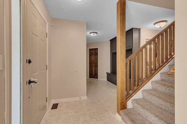 2668 Waterford Ct, Saint Cloud, MN 56301 - foyer featuring a textured ceiling and stairway