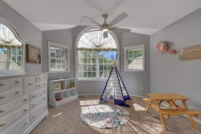 2668 Waterford Ct, Saint Cloud, MN 56301 - rec room featuring vaulted ceiling, a ceiling fan, light carpet, and a textured ceiling