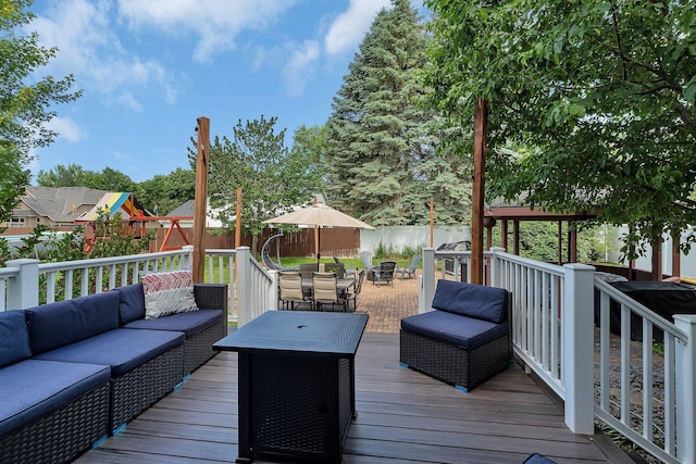 2668 Waterford Ct, Saint Cloud, MN 56301 - wooden terrace featuring outdoor lounge area, a fenced backyard, a playground, and outdoor dining space