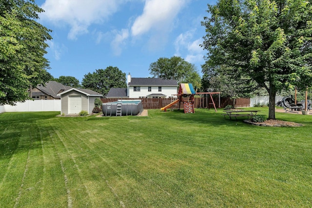 2668 Waterford Ct, Saint Cloud, MN 56301 - fenced backyard with a playground, a pool, and a shed