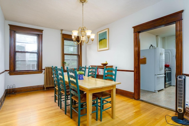 63 Avon St S Unit 36, Saint Paul, MN 55105 - dining area featuring light wood-type flooring and a chandelier