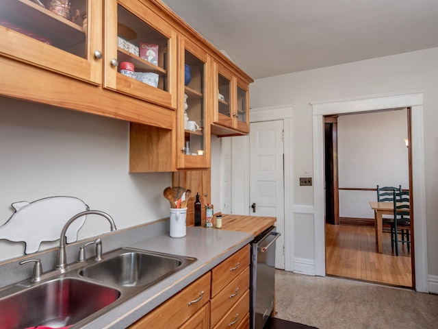 63 Avon St S Unit 36, Saint Paul, MN 55105 - kitchen with dishwasher, brown cabinetry, and glass insert cabinets