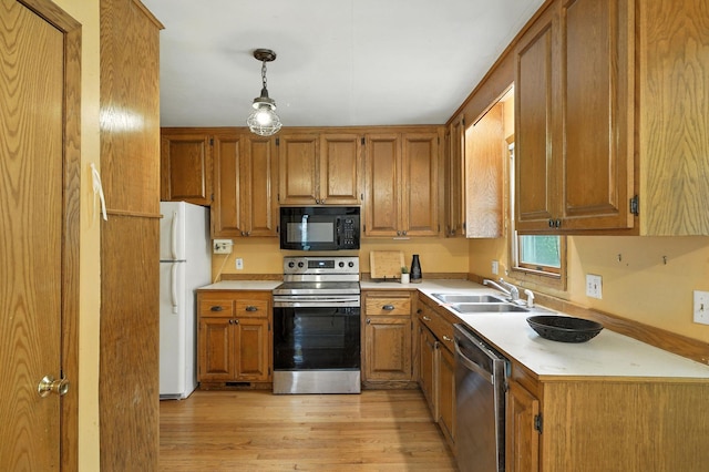 6398 Osman Ave N, Oak Park Heights, MN 55082 - kitchen with appliances with stainless steel finishes, light countertops, light wood-style floors, and brown cabinets
