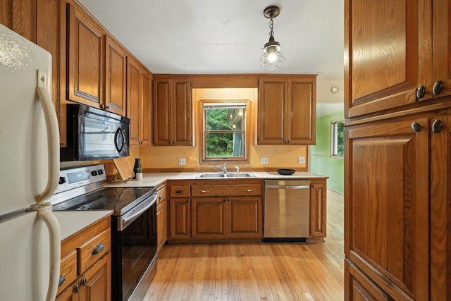 6398 Osman Ave N, Oak Park Heights, MN 55082 - kitchen featuring appliances with stainless steel finishes, brown cabinets, and plenty of natural light