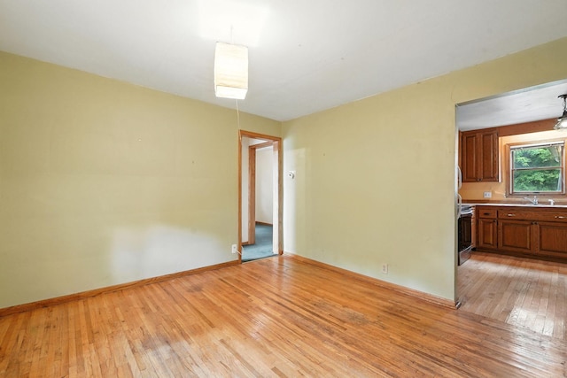 6398 Osman Ave N, Oak Park Heights, MN 55082 - unfurnished room with light wood finished floors and baseboards