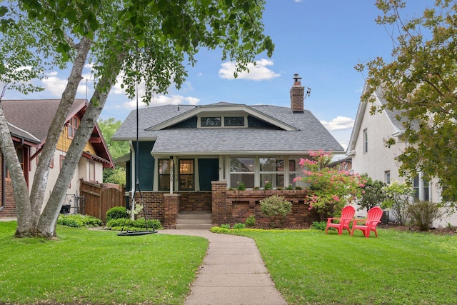 4708 Pleasant Ave, Minneapolis, MN 55419 - bungalow-style house with a chimney, roof with shingles, and brick siding