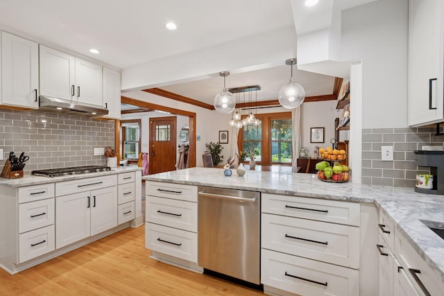 4708 Pleasant Ave, Minneapolis, MN 55419 - kitchen featuring appliances with stainless steel finishes, a peninsula, under cabinet range hood, white cabinets, and backsplash