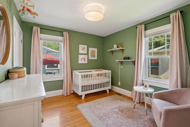 4708 Pleasant Ave, Minneapolis, MN 55419 - bedroom with light wood finished floors and a nursery area