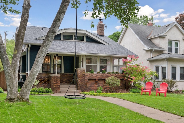 4708 Pleasant Ave, Minneapolis, MN 55419 - view of front of house with roof with shingles, a front lawn, a chimney, and brick siding