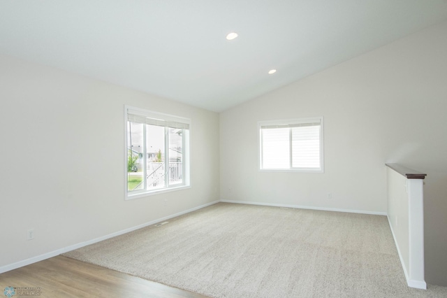1381 Westport Beach Way W, Fargo, ND 58078 - unfurnished room with healthy amount of natural light, vaulted ceiling, recessed lighting, and light carpet