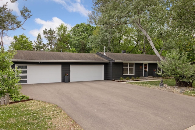 18201 Kathleene Dr, Minnetonka, MN 55345 - view of front of property featuring asphalt driveway, an attached garage, and a shingled roof