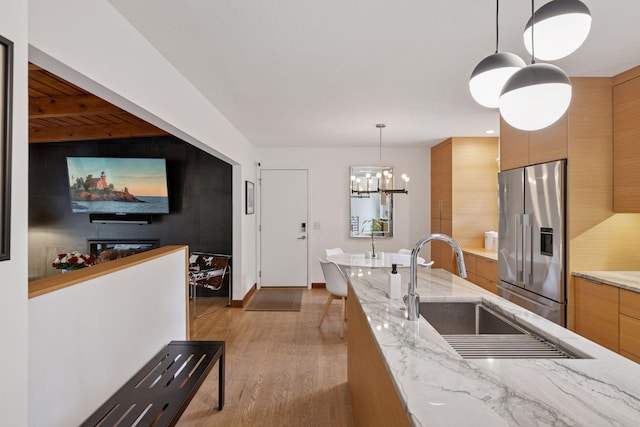 18201 Kathleene Dr, Minnetonka, MN 55345 - kitchen featuring stainless steel refrigerator with ice dispenser, modern cabinets, wood finished floors, a chandelier, and pendant lighting