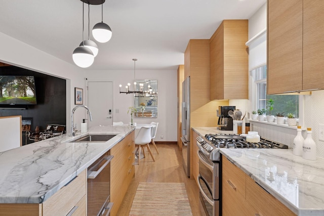 18201 Kathleene Dr, Minnetonka, MN 55345 - kitchen featuring appliances with stainless steel finishes, modern cabinets, light wood finished floors, and light stone counters
