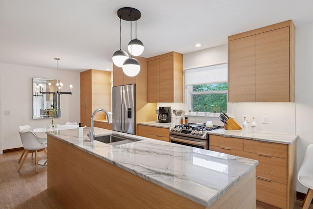 18201 Kathleene Dr, Minnetonka, MN 55345 - kitchen featuring appliances with stainless steel finishes, a kitchen island with sink, wood finished floors, decorative backsplash, and modern cabinets