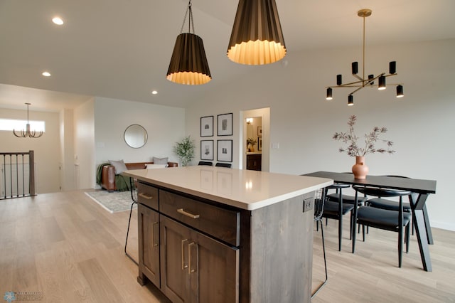 6153 Martin Ln W, West Fargo, ND 58078 - kitchen featuring a chandelier, light wood-style floors, a center island, a kitchen bar, and recessed lighting