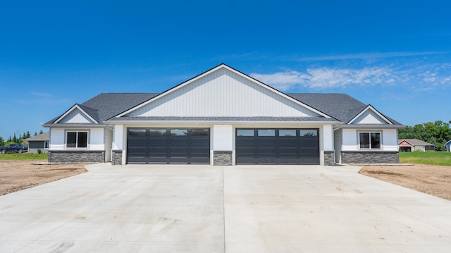 322 Old Glory Dr NE, Alexandria, MN 56308 - modern farmhouse style home with stone siding, a garage, driveway, and a shingled roof