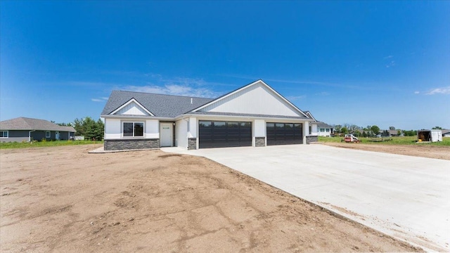 322 Old Glory Dr NE, Alexandria, MN 56308 - view of front of property with stone siding, a garage, and driveway