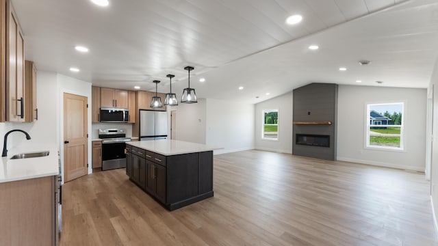 322 Old Glory Dr NE, Alexandria, MN 56308 - kitchen featuring stainless steel appliances, recessed lighting, light wood-type flooring, a kitchen island, and open floor plan