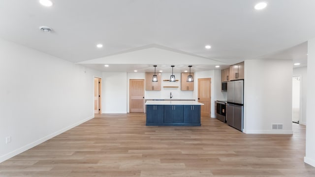 322 Old Glory Dr NE, Alexandria, MN 56308 - kitchen featuring stainless steel appliances, recessed lighting, light countertops, open floor plan, and light wood finished floors